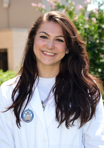 Headshot of medical student Alana Lelo wearing a white lab coat